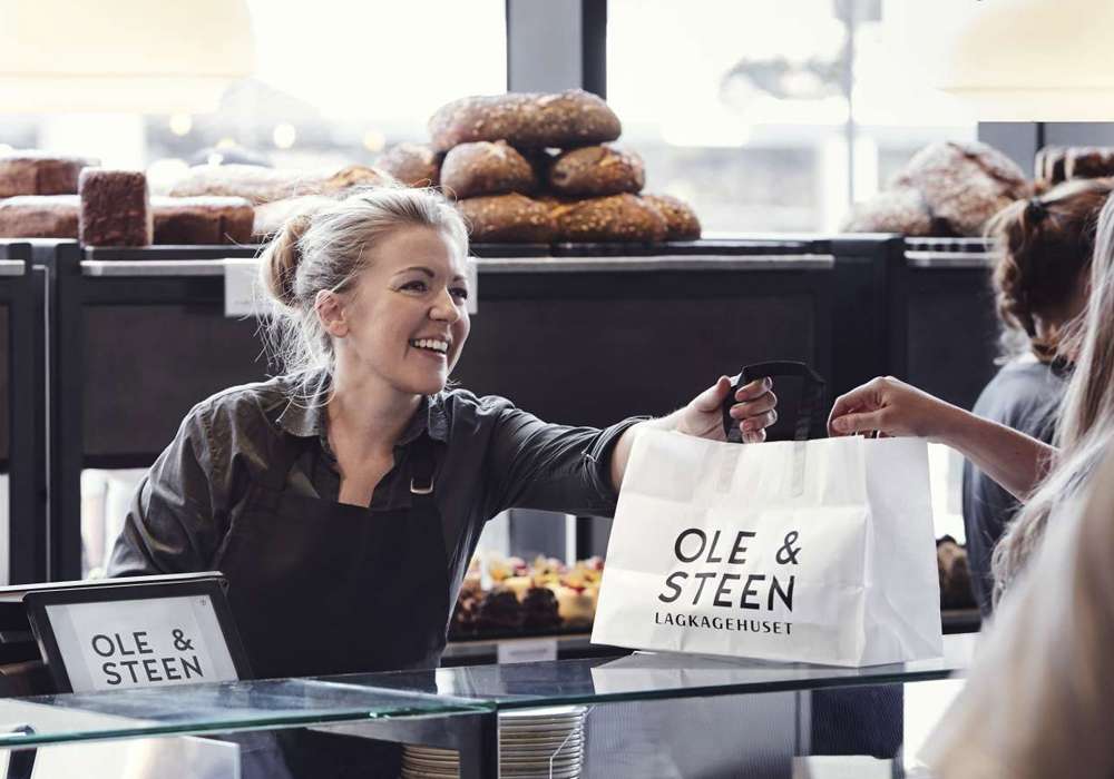 Indside Ole and steen store handing over baked goods